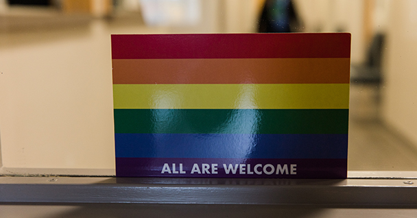 rainbow flag with "all are welcome" on it